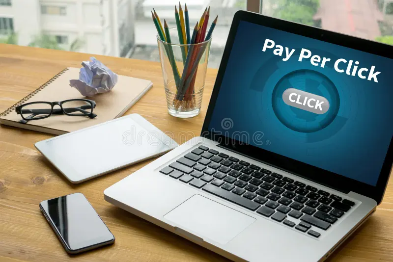 ppc pay per click concept laptop table warm tone 79704107